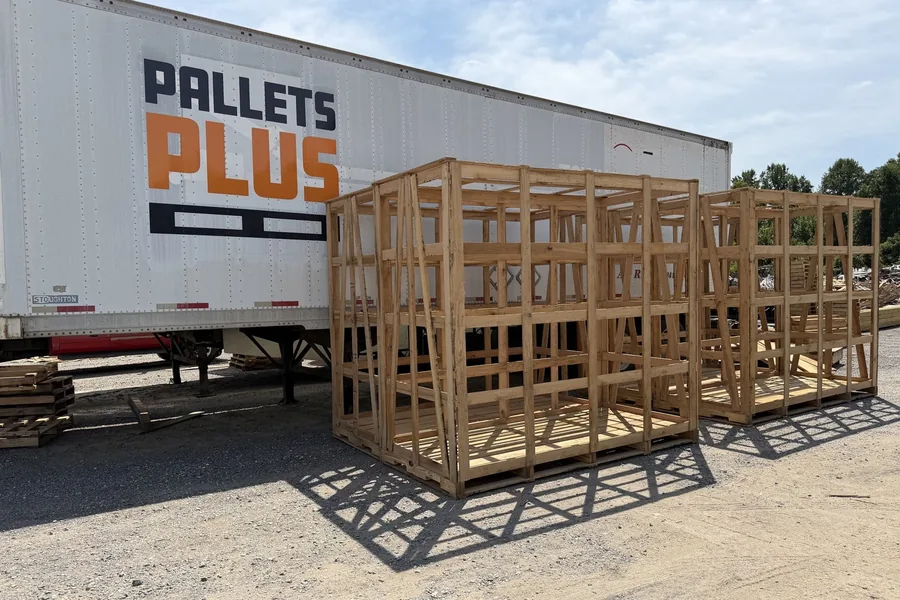 Two large custom shipping crates strapped to a flatbed trailer, ready to leave the Clinton yard
